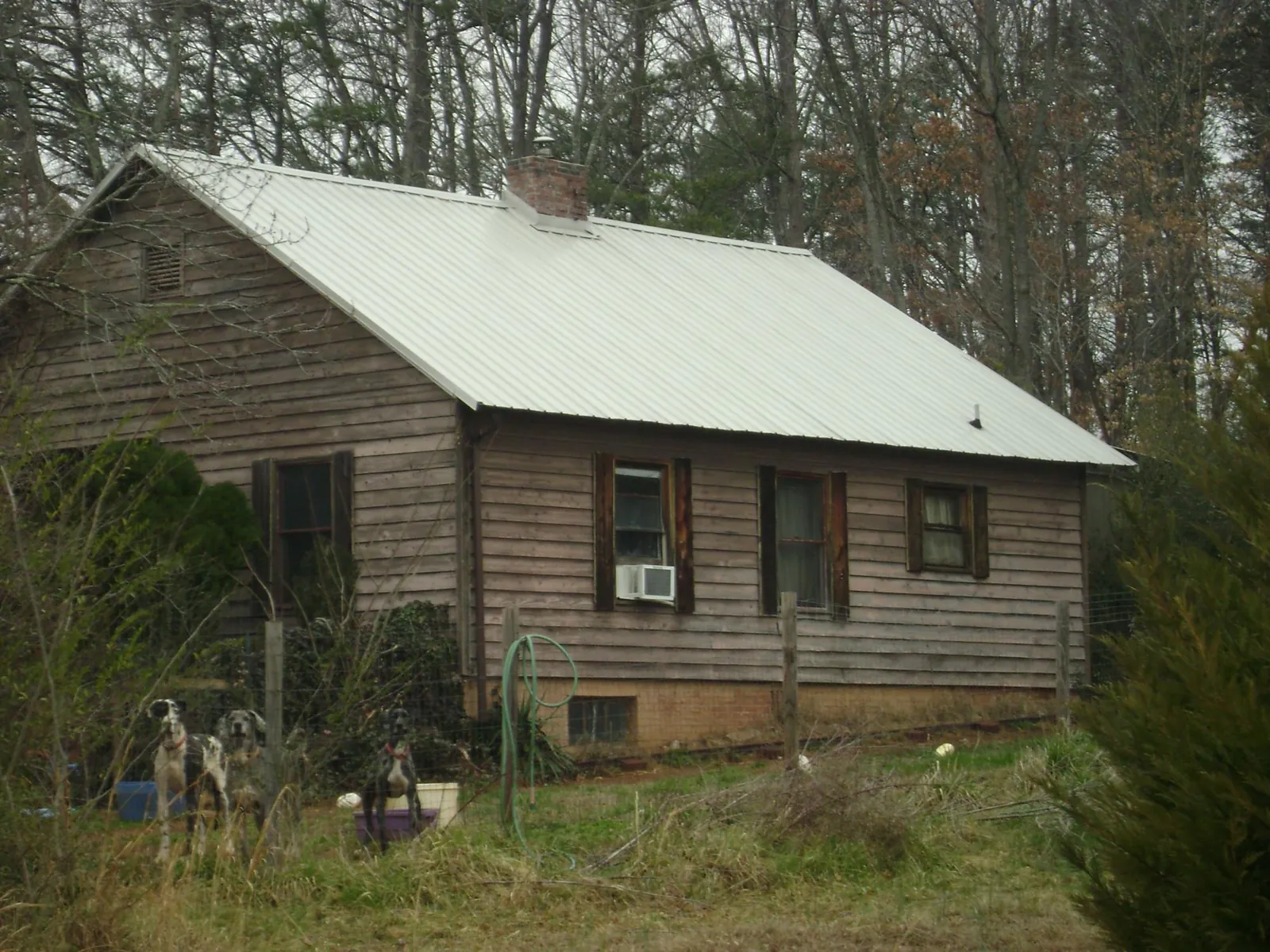 White metal roof on an old wood sided farmhouse, from a Metal Roof Installation job in Talbott